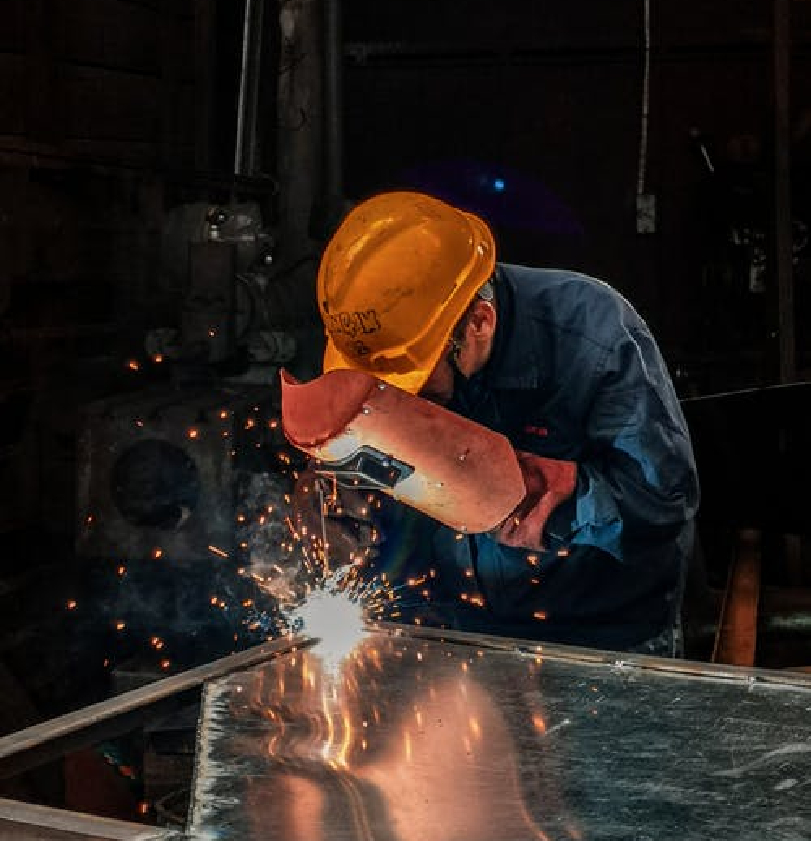 man welding a metal sheet